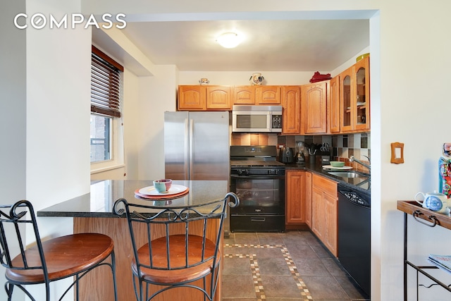 5700 Arlington Ave Unit 16T, New York City, NY 10471 - kitchen with black appliances, a sink, inlaid floor details, glass insert cabinets, and a kitchen bar