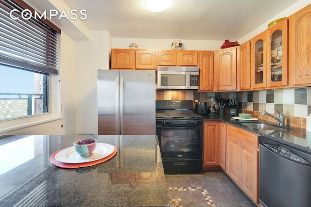 5700 Arlington Ave Unit 16T, New York City, NY 10471 - kitchen with appliances with stainless steel finishes, a sink, glass insert cabinets, dark stone counters, and backsplash