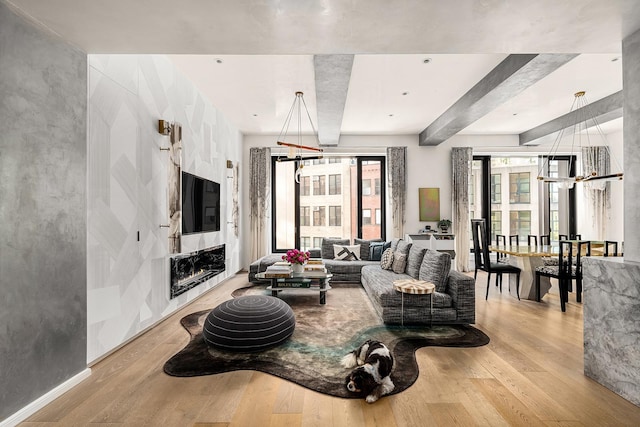 11 Beach St Unit 5B, New York City, NY 10013 - living room featuring beam ceiling, wood finished floors, and a fireplace