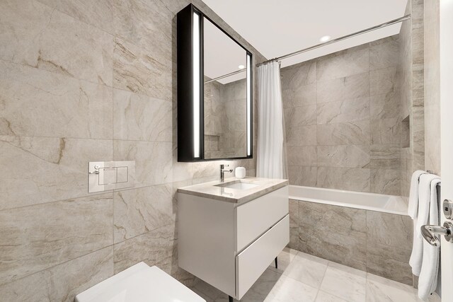 11 Beach St Unit 5B, New York City, NY 10013 - full bathroom featuring tiled shower / bath, tile walls, vanity, and marble finish flooring