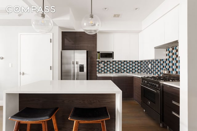 476 Hancock St Unit 3, New York City, NY 11233 - kitchen with appliances with stainless steel finishes, modern cabinets, light countertops, a kitchen bar, and backsplash