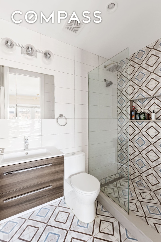 476 Hancock St Unit 3, New York City, NY 11233 - full bathroom with tiled shower, vanity, tile walls, toilet, and tile patterned floors