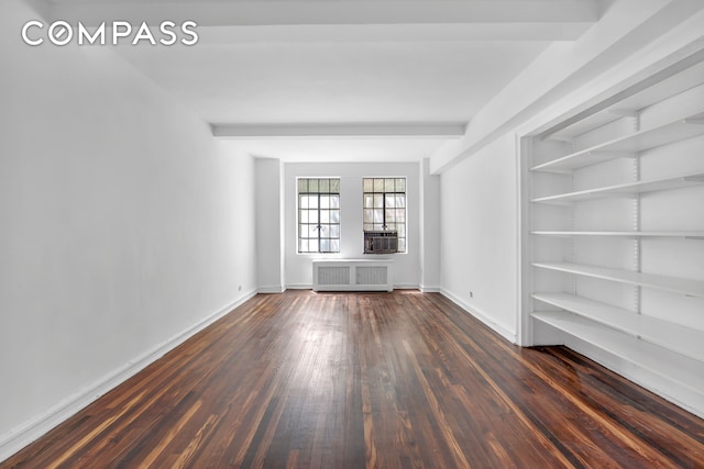 320 E 42nd St Unit 516, New York City, NY 10017 - unfurnished room featuring radiator heating unit, dark wood-style flooring, and cooling unit