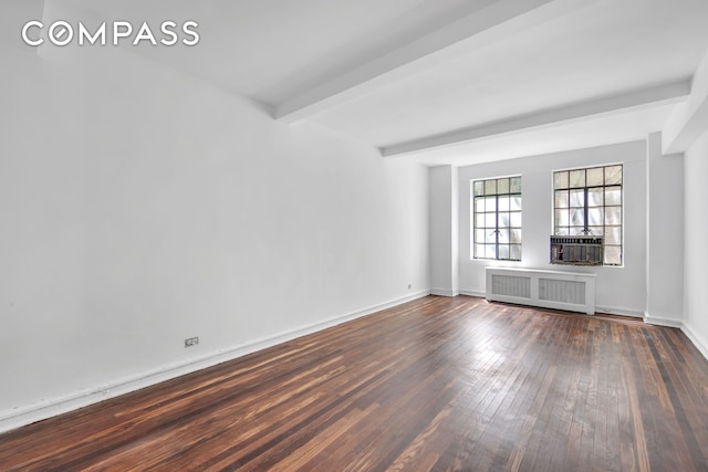 320 E 42nd St Unit 516, New York City, NY 10017 - empty room featuring radiator, dark wood-type flooring, beamed ceiling, and cooling unit