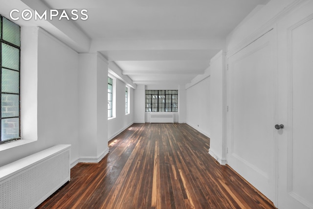320 E 42nd St Unit 418, New York City, NY 10017 - empty room with radiator heating unit, wood-type flooring, and baseboards