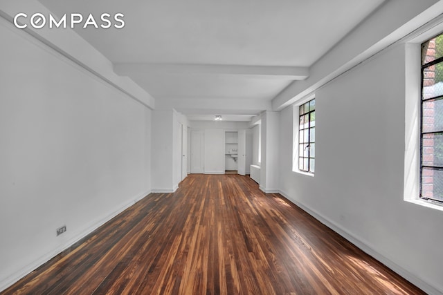 320 E 42nd St Unit 418, New York City, NY 10017 - spare room featuring wood finished floors, baseboards, and beam ceiling