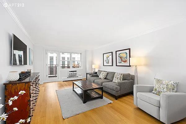 340 E 80th St Unit 20-J, New York City, NY 10075 - living area with crown molding and light wood-style flooring
