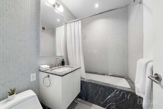 210 Lafayette St Unit 5A, New York City, NY 10012 - full bath featuring vanity, tile walls, toilet, recessed lighting, and a combined bath / shower with marble appearance