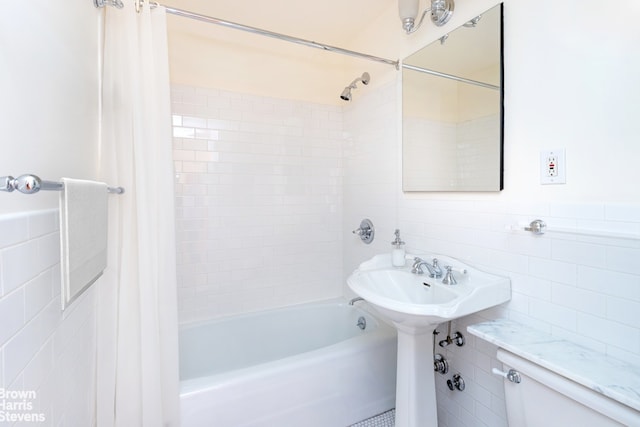 520 E 81st St Unit 14G, New York City, NY 10028 - bathroom with tile walls, shower / bath combination with curtain, and toilet