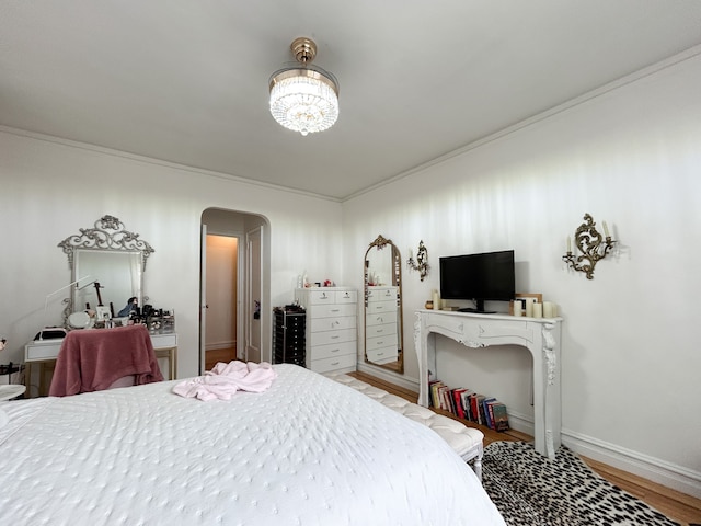 100 Bennett Ave Unit 4B, New York City, NY 10033 - bedroom with arched walkways, wood finished floors, a chandelier, crown molding, and baseboards