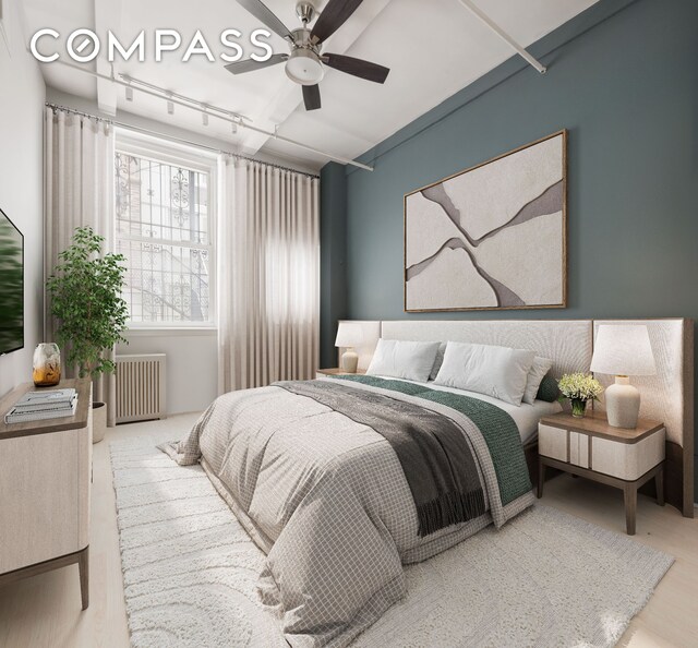 28 W 38th St Unit 6E, New York City, NY 10018 - bedroom featuring radiator, wood finished floors, and ceiling fan