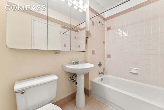 4-74 48th Ave Unit Ph2B, New York City, NY 11109 - bathroom featuring toilet, shower / bathtub combination, tile patterned floors, and baseboards