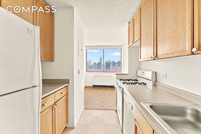 4-74 48th Ave Unit Ph2B, New York City, NY 11109 - kitchen featuring white appliances, light countertops, a textured ceiling, a sink, and a skyline view