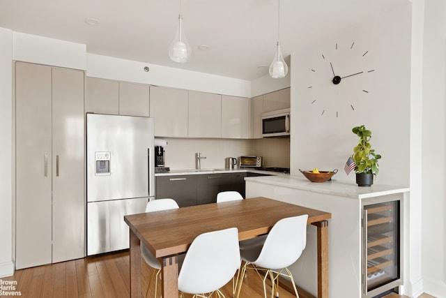 505 W 47th St Unit Ph2S, New York City, NY 10036 - kitchen with stainless steel fridge, wine cooler, white microwave, gray cabinets, and a sink