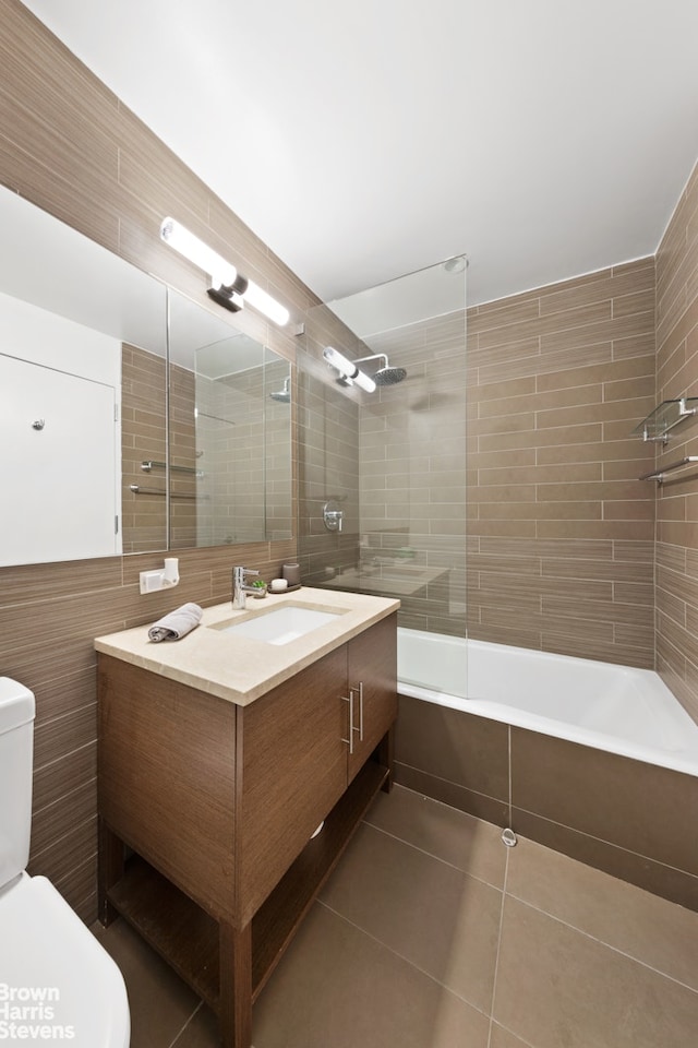 505 W 47th St Unit Ph2S, New York City, NY 10036 - full bathroom featuring tile walls, toilet, vanity, tile patterned flooring, and shower / bath combination