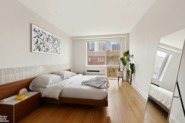 505 W 47th St Unit Ph2S, New York City, NY 10036 - bedroom with light wood finished floors and an AC wall unit