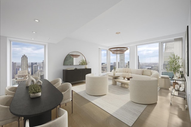 138 E 50th St Unit Tr67, New York City, NY 10022 - living area featuring light wood-style floors, a skyline view, and recessed lighting