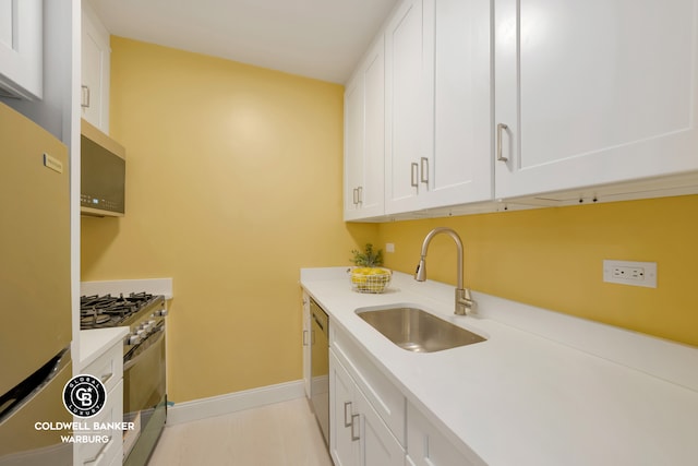 233 E 86th St Unit 4A, New York City, NY 10028 - kitchen featuring a sink, stainless steel appliances, white cabinetry, baseboards, and light countertops