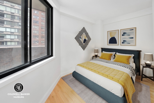 233 E 86th St Unit 4A, New York City, NY 10028 - bedroom featuring wood finished floors and baseboards