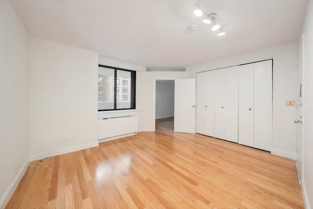 233 E 86th St Unit 4A, New York City, NY 10028 - unfurnished bedroom with light wood-style flooring and a closet