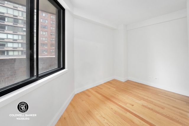 233 E 86th St Unit 4A, New York City, NY 10028 - unfurnished room with healthy amount of natural light, wood finished floors, and baseboards