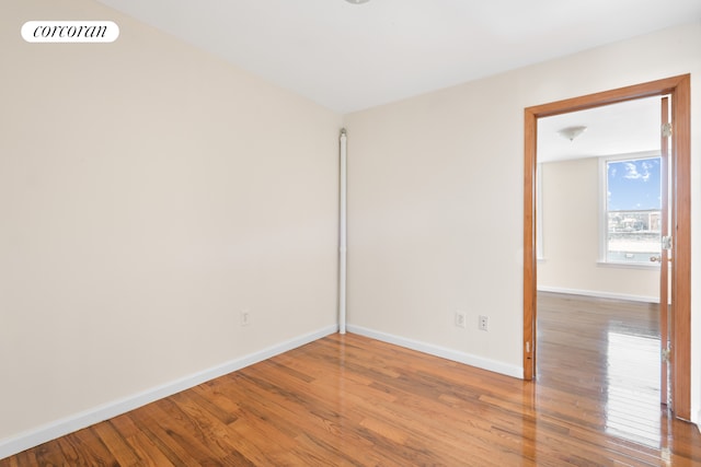 238 26th St, New York City, NY 11232 - empty room with baseboards and wood finished floors