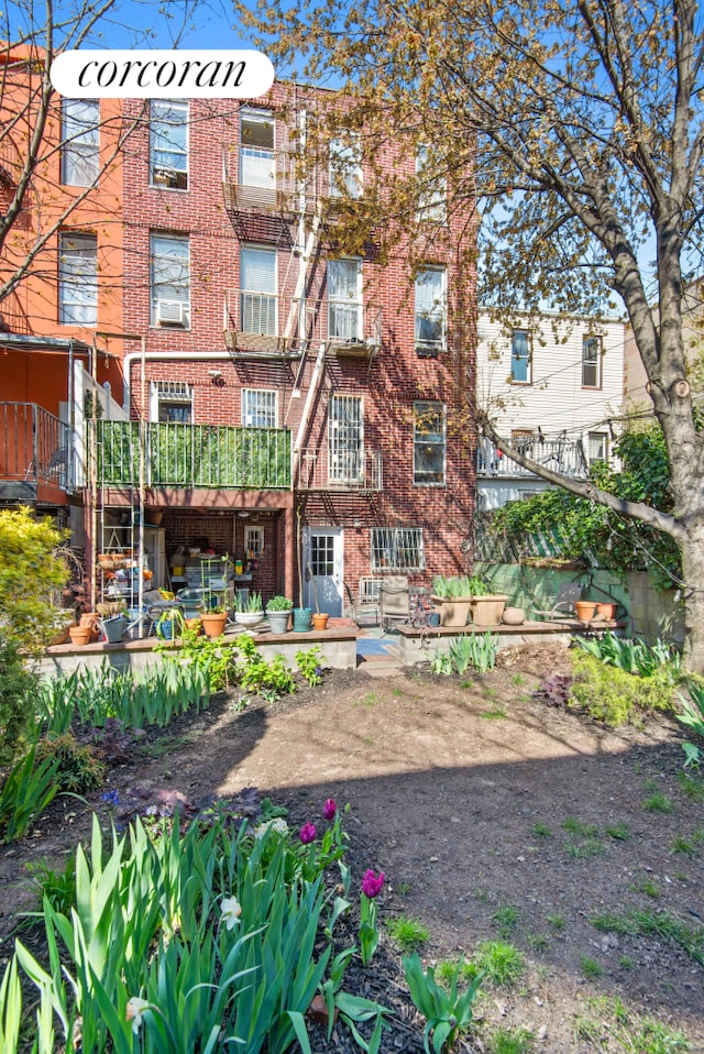 238 26th St, New York City, NY 11232 - rear view of property with brick siding and a patio area