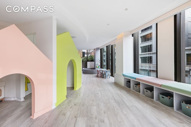 90 Furman St Unit N107, New York City, NY 11201 - corridor featuring wood finished floors, arched walkways, baseboards, and expansive windows