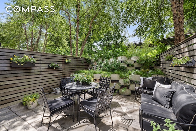 90 Furman St Unit N107, New York City, NY 11201 - fenced backyard featuring outdoor dining space, a patio area, and outdoor lounge area