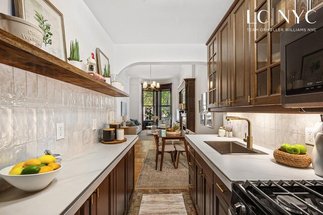 632 W End Ave Unit 2F, New York City, NY 10024 - kitchen with a sink, light countertops, a chandelier, and backsplash