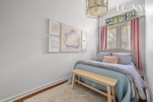 632 W End Ave Unit 2F, New York City, NY 10024 - bedroom featuring a chandelier, wood finished floors, and baseboards