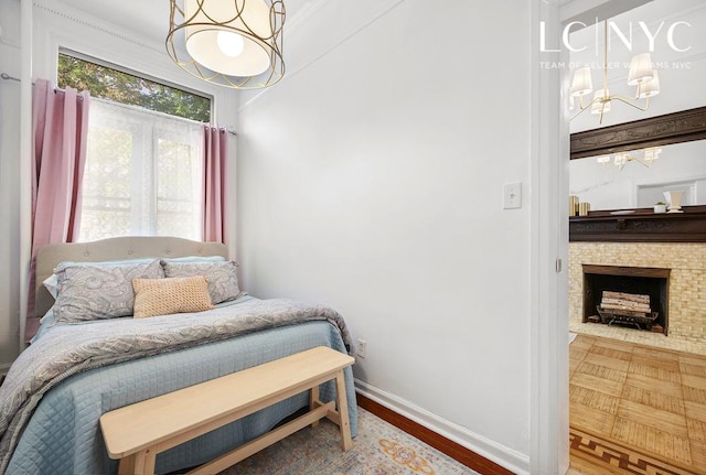 632 W End Ave Unit 2F, New York City, NY 10024 - bedroom featuring a chandelier, baseboards, and a fireplace
