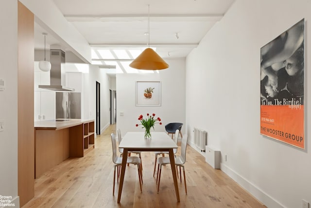 46 Great Jones St Unit 7, New York City, NY 10012 - dining space featuring radiator, light wood-style floors, and baseboards