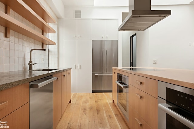 46 Great Jones St Unit 7, New York City, NY 10012 - kitchen featuring appliances with stainless steel finishes, ventilation hood, a sink, open shelves, and backsplash