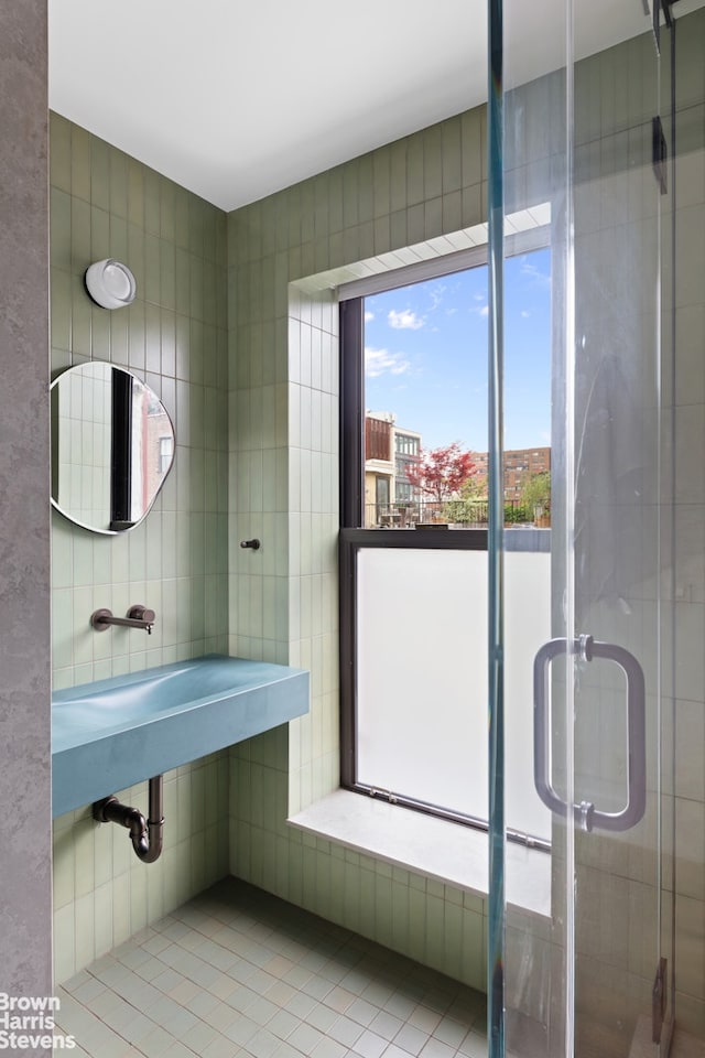 46 Great Jones St Unit 7, New York City, NY 10012 - bathroom with healthy amount of natural light, a shower stall, and tile patterned floors