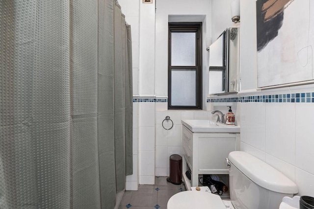 255 W 108th St Unit 2F, New York City, NY 10025 - full bath featuring tile walls, vanity, curtained shower, tile patterned floors, and wainscoting