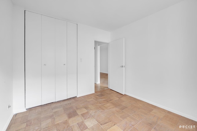 345 E 80th St Unit 5-L, New York City, NY 10075 - unfurnished bedroom featuring baseboards and a closet