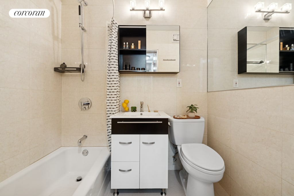 10 W 15th St Unit 1822, New York City, NY 10011 - bathroom with tile walls, toilet,  shower combination, and vanity