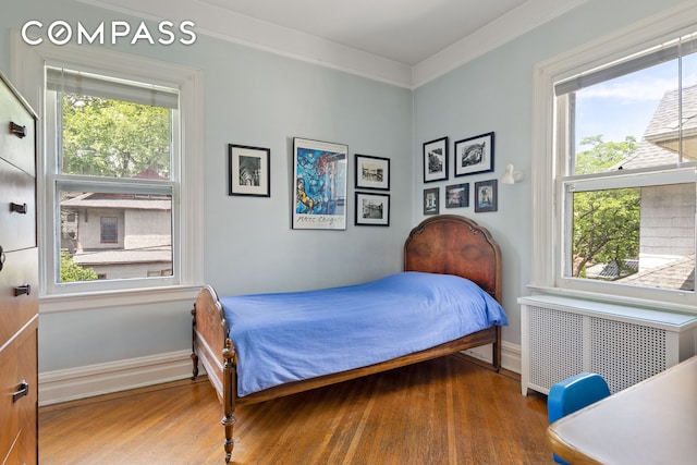 492 Westminster Rd, New York City, NY 11218 - bedroom with radiator heating unit, wood finished floors, ornamental molding, and baseboards