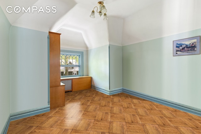 492 Westminster Rd, New York City, NY 11218 - spare room with radiator heating unit, a chandelier, and lofted ceiling