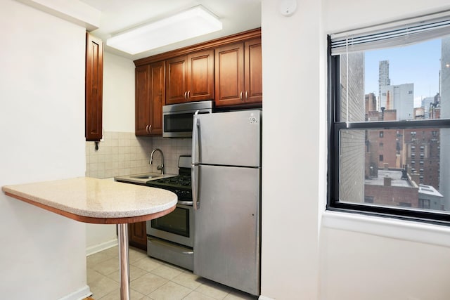 155 E 38th St Unit 19A, New York City, NY 10016 - kitchen featuring appliances with stainless steel finishes, a sink, decorative backsplash, light tile patterned floors, and a view of skyline