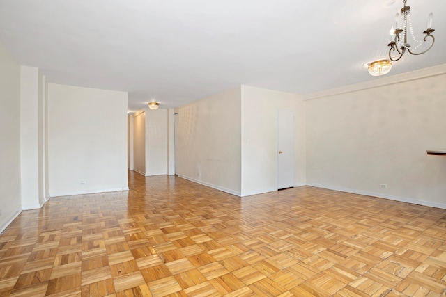 155 E 38th St Unit 19A, New York City, NY 10016 - unfurnished room with baseboards and a chandelier