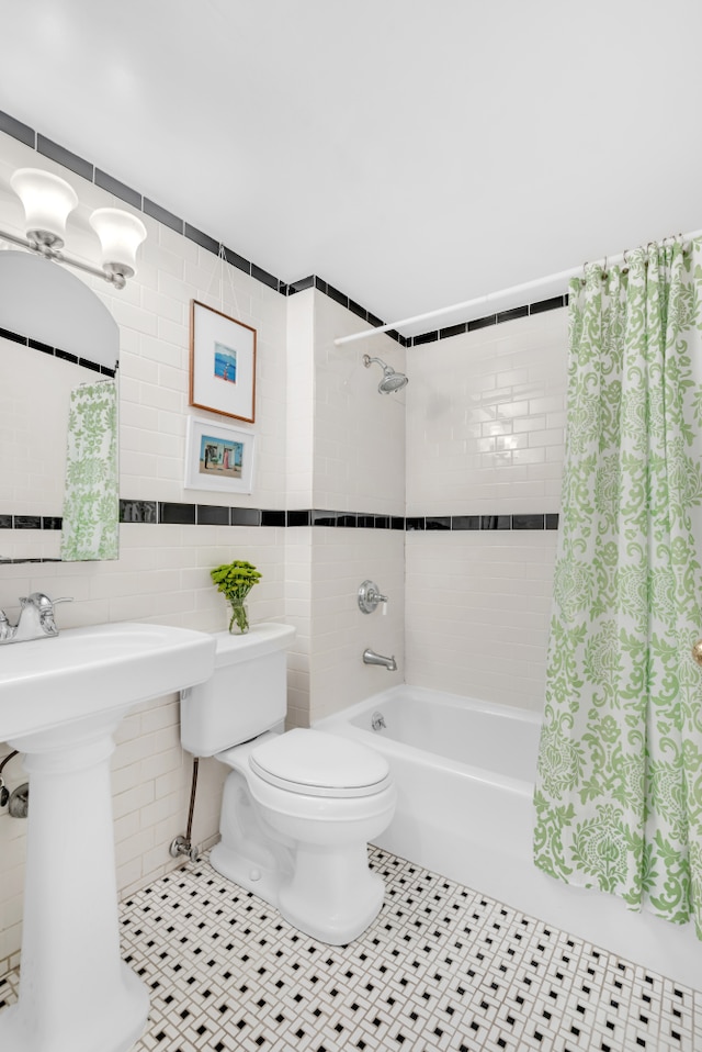 22 Irving Pl Unit 1E, New York City, NY 10003 - bathroom with tile walls, shower / tub combo, and tile patterned floors