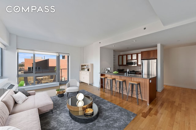 460 W 236th St Unit 65, New York City, NY 10463 - living room featuring light wood-style flooring and baseboards