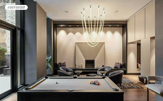 91 Leonard St Unit 7H, New York City, NY 10013 - playroom featuring wood finished floors, pool table, plenty of natural light, and a chandelier