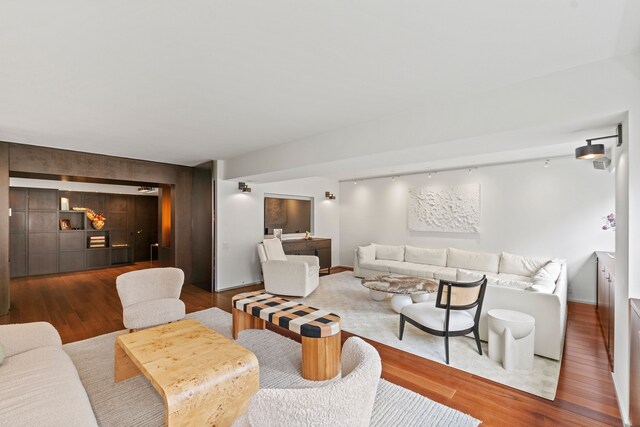 40 E 78th St Unit 7-H, New York City, NY 10075 - living area featuring wood finished floors, an accent wall, and baseboards