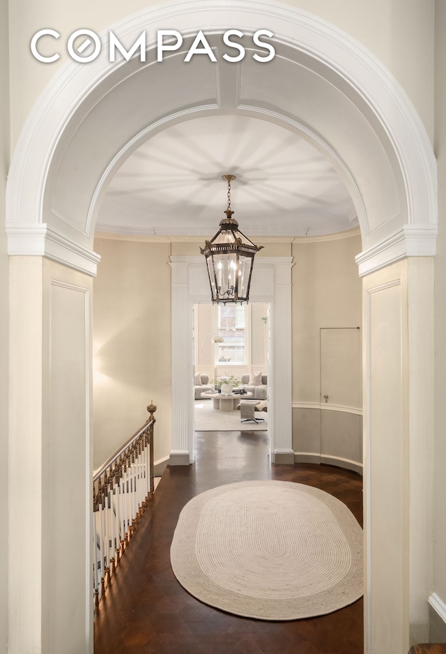 46 E 71st St, New York City, NY 10021 - corridor featuring a chandelier, arched walkways, and wood finished floors