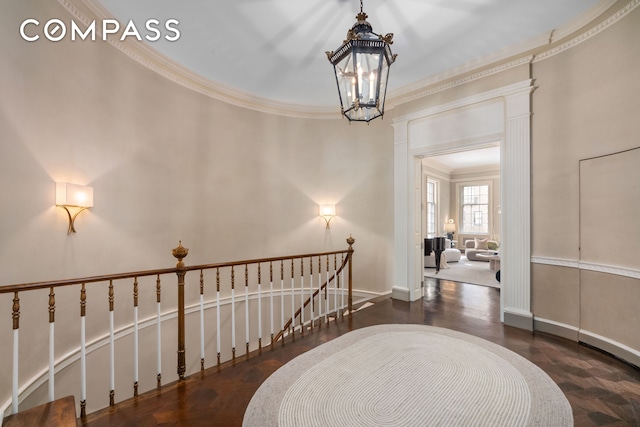46 E 71st St, New York City, NY 10021 - corridor with a chandelier, wood finished floors, crown molding, an upstairs landing, and baseboards
