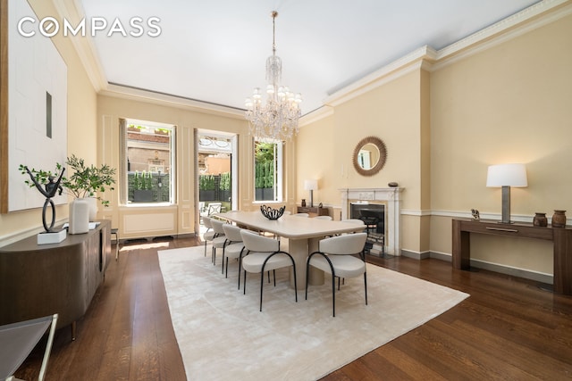 46 E 71st St, New York City, NY 10021 - dining area with a chandelier, dark wood finished floors, ornamental molding, a high end fireplace, and baseboards