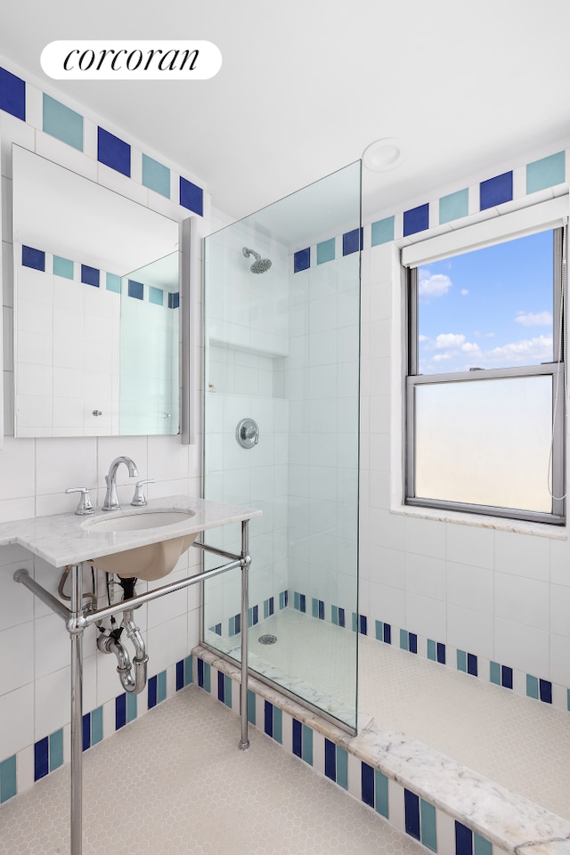 175 W 13th St Unit 14D, New York City, NY 10011 - bathroom with tiled shower, tile walls, and a sink